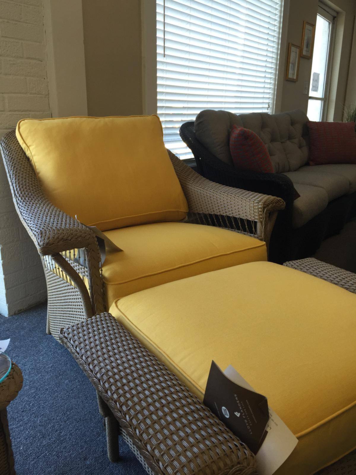 A yellow cushioned outdoor chaise and chairs