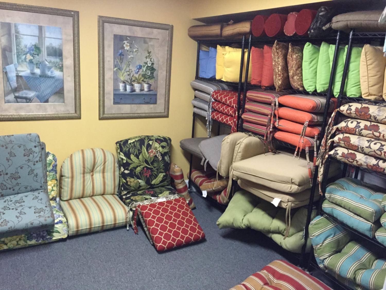 A wall of outdoor cushions in many colors and patterns