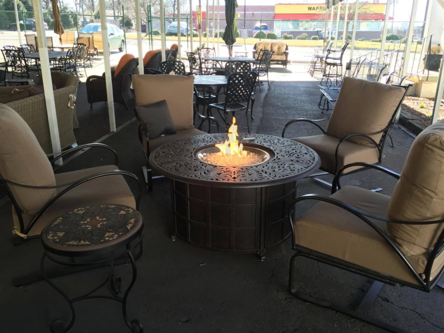 Outdoor seating arranged around a lit fire pit table