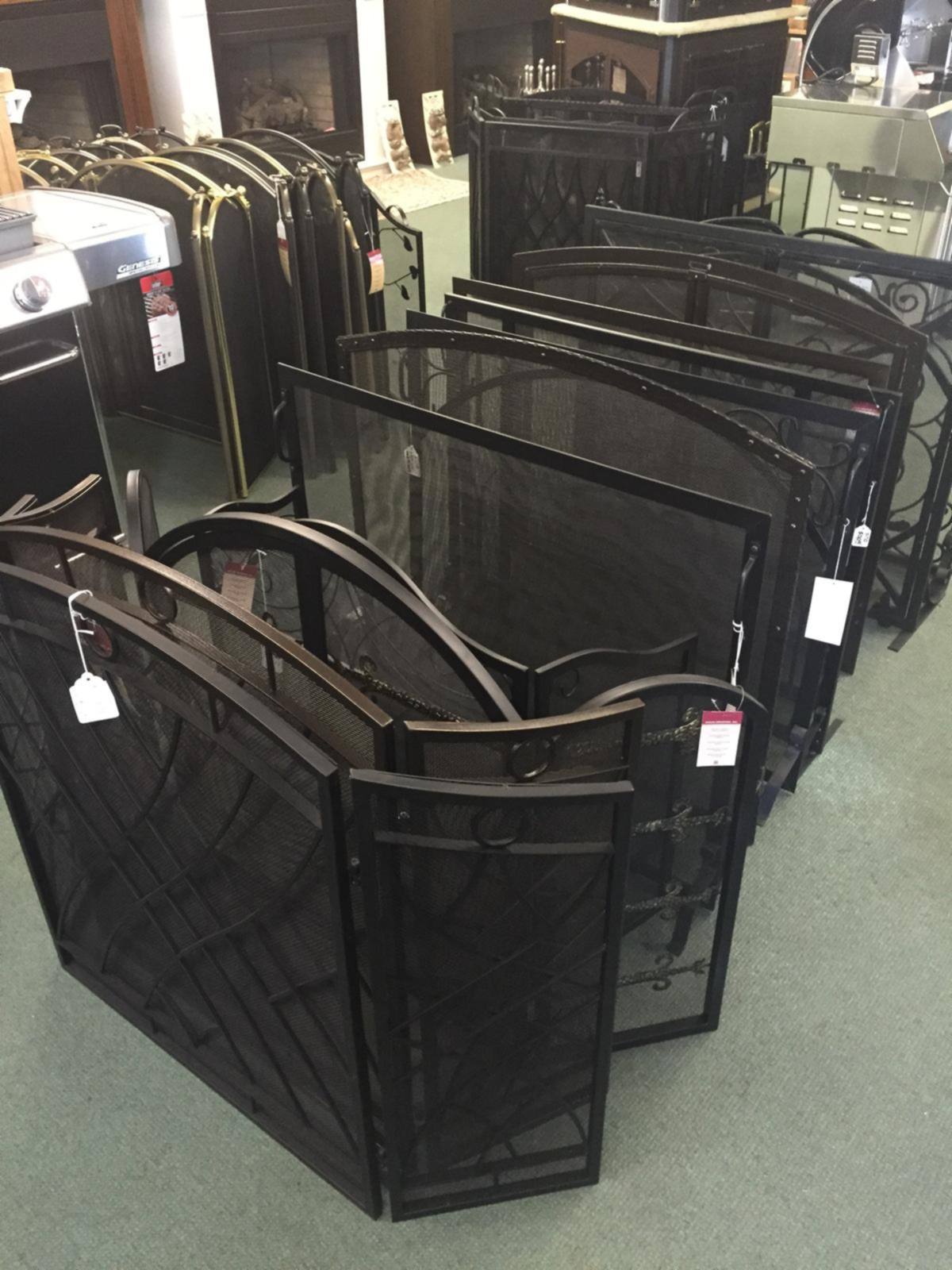 A rack of fireplace screens on our showroom floor