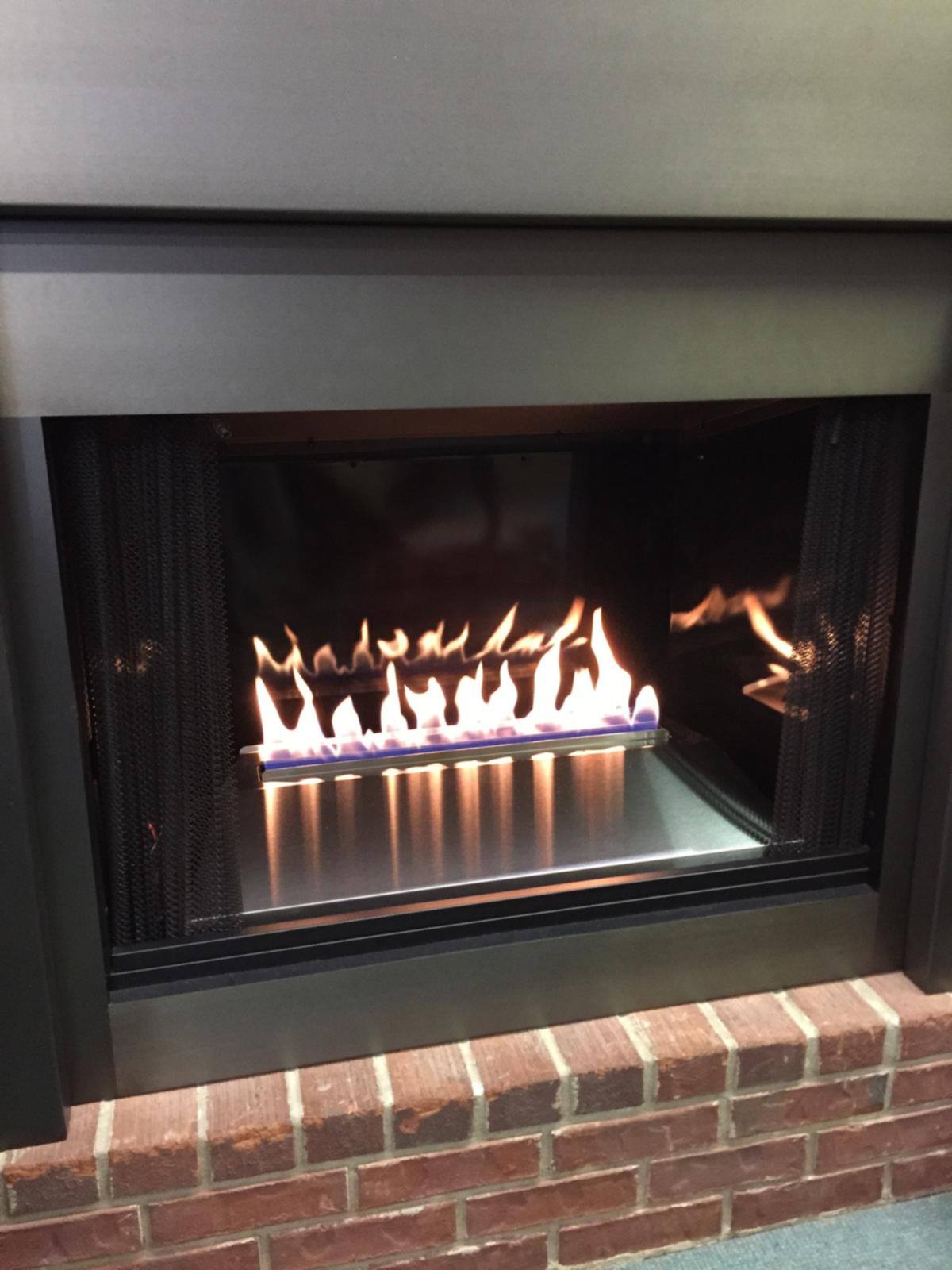 A contemporary linear gas unit burning in our showroom