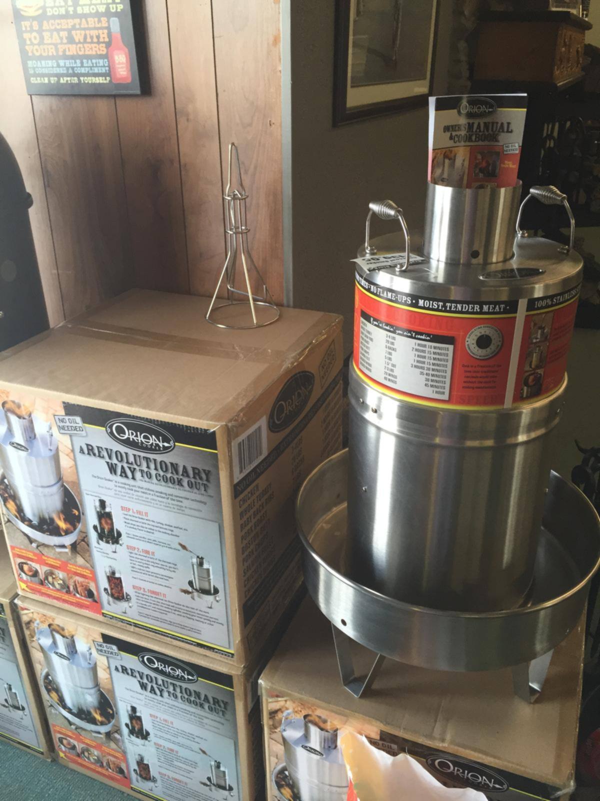 A stainless outdoor cooker on a stand in our showroom