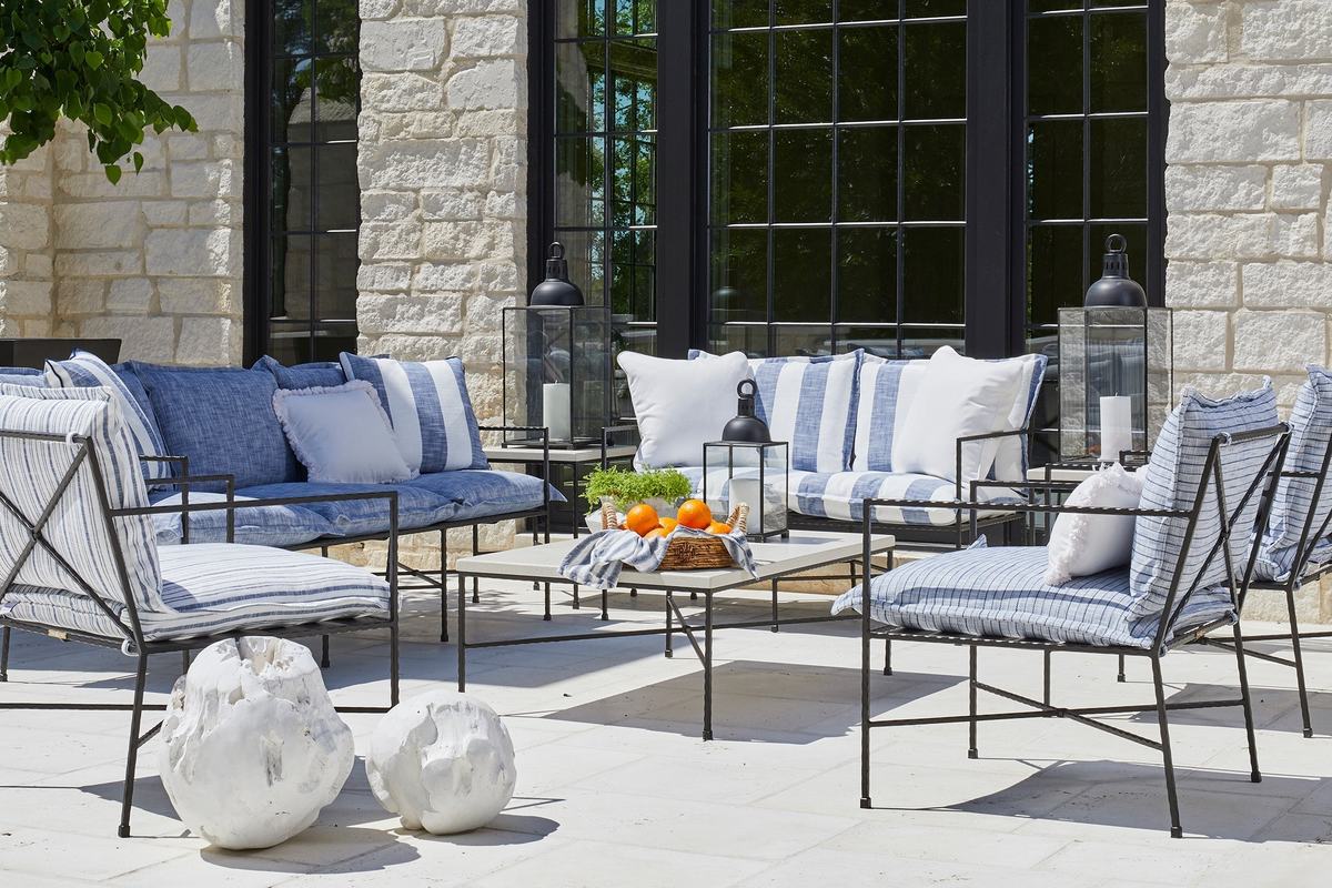 A Summer Classics Italia sofa and chairs with blue and white striped cushions on a stone terrace